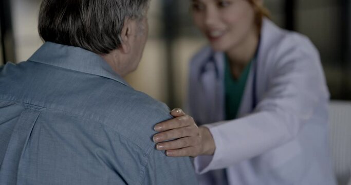 Doctor comforting patient by touching shoulder	
