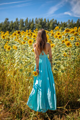 Obraz premium Woman in Summer Dress Embracing the Beauty of Sunflowers and the Hope for Peace
