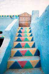 Colorful stairs and blue walls in a Nubian village, Egypt