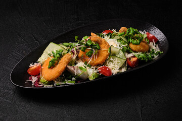 Caesar salad wit shrimp stile on a black background