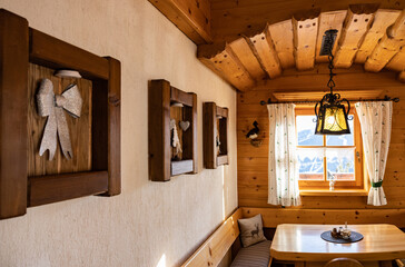 Fototapeta na wymiar Beautifully decorated wall by the window in a cozy Austrian restaurant in the ski resort