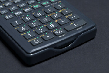 Scientific calculator isolated on black paper background