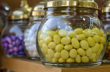 Delicious sweet dragees in colored glaze in glass jars on a store counter in Turkey