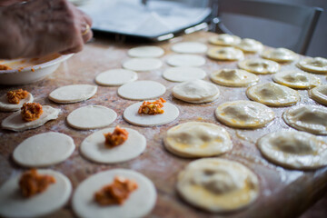 Filling and sealing puff pastry dumplings in a kitchen