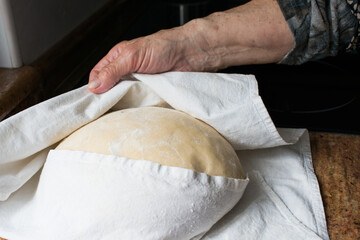 Unrecognizable human hanad checking the casadielles dough during rising