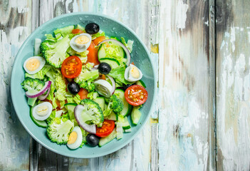 Vegetable salad. Salad of tomatoes, cucumbers and quail eggs with olive oil.