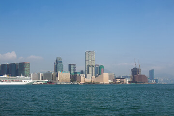 Fototapeta na wymiar Panorama of Kowloon waterfront and Victoria Bay and cruise ship (possibly in Macau)