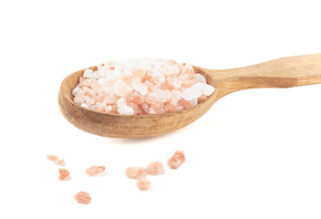 Fototapeta na wymiar Large crystals of Himalayan pink salt in a wooden spoon and on a white background.