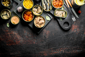 Assortment of various canned food in open cans.