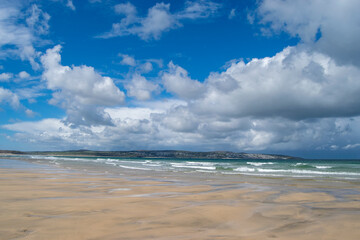 A picturesque beach on a sunny day in Cornwall, UK.