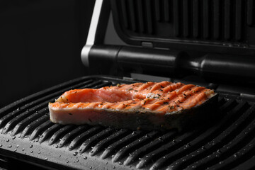 Cooking salmon. Grill with tasty fish steak and spices