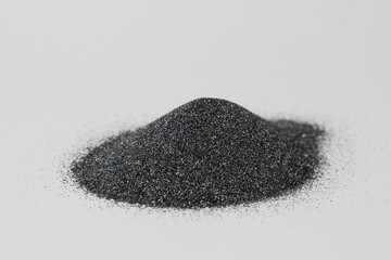 Silicon carbide powder close-up isolated on white background. Silicon carbide abrasive grit for restore stones to original flatness and leveling sharpening stones.