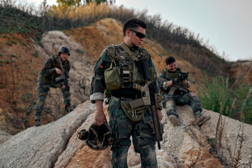 Squad of Fully Equipped Soldiers in Camouflage on Reconnaissance Military Mission, Wearing Military...