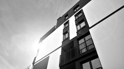 Fototapeta premium Apartments in residential complex. Housing structure at modern house. Architecture for property investment. and architecture details. Urban abstract - windows of apartment building. Black and white.