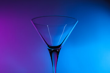 Empty clean martini glass in neon lights
