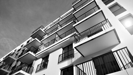 Fototapeta premium Apartments in residential complex. Housing structure at modern house. Architecture for property investment. and architecture details. Urban abstract - windows of apartment building. Black and white.