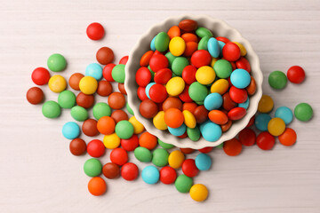 Tasty colorful candies on white wooden table, flat lay