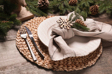 Luxury place setting with beautiful festive decor for Christmas dinner on wooden table, closeup