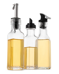 Glass bottles of cooking oil on white background