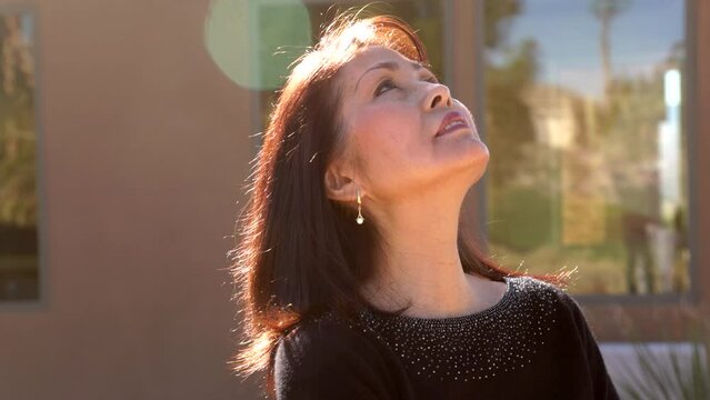 Attractive Middle Age Woman Looking To The Sky Head Shot Back Lit