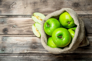 Fototapeta na wymiar Green apples and Apple slices in an old bag.
