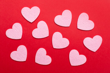 Felt hearts on color background, top view