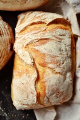 Bakery products. Crispy, beautiful bread on a dark background. Top view, place for text.