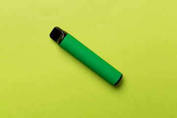 Disposable electronic cigarette on color background, top view