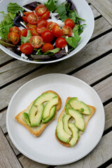 Toast with avocado on a white plate