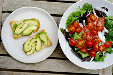 Toast with avocado on a white plate