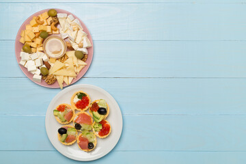 Different tasty snacks for party on wooden background, top view