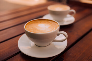 Two cups of cappuccino with latte art