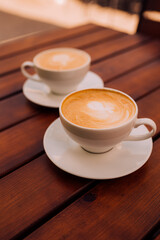 Two cups of cappuccino with latte art