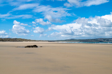 A picturesque beach on a sunny day in Cornwall, UK.