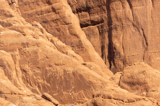 A sandstone rock wall showing many layers showing the detail and color of the rock.