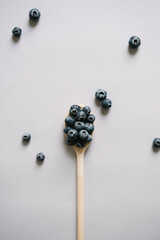 Blueberry berries on wooden spoon