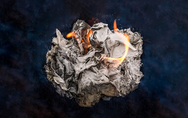 crumpled paper ball burned with fire