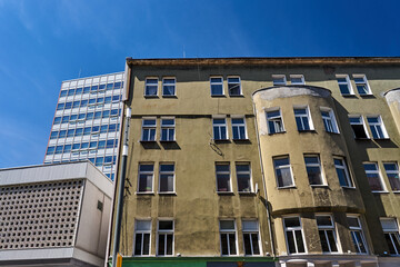 Fototapeta premium the facade of a historic tenement house and a fragment of a modern office building in the city of Poznan