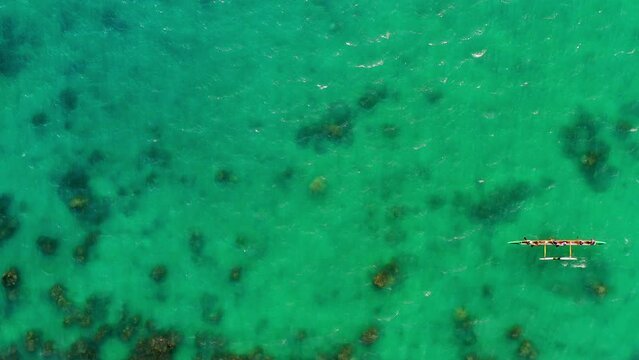 Aerial Top View Of People Rowing In Blue Sea On Sunny Day - Oahu, Hawaii