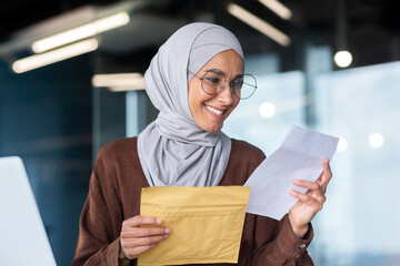 Businesswoman in hijab close up reading notification, Muslim woman received postal envelope letter...