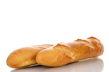 Two fresh fragrant baguettes, macro, isolated on white background.