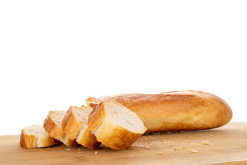 One fresh fragrant baguette cut into slices on a wooden board, macro, isolated on white background.