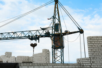 Fototapeta premium Construction site with tower crane near unfinished building