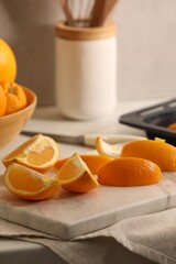 Fresh orange peels and juicy fruits on white table