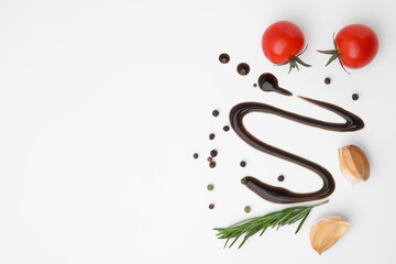 Organic balsamic vinegar and cooking ingredients on white background, flat lay. Space for text