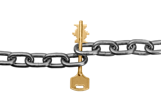 Gold key tangled up in a metal chain