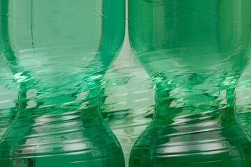 Timeless beauty of a plastic bottle in bright green. The slim middle part of a plastic water bottle.