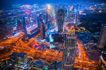 Fototapeta na wymiar Dubai city at night, view with lit up skyscrapers and roads. Dubai, UAE 2022