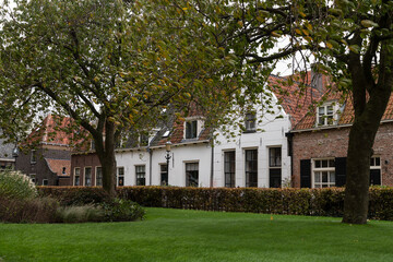 Fototapeta na wymiar Small houses at the former beguinage near the Saint Nicholas Church in the Dutch Hanseatic city of Elburg.
