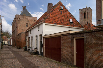Former town hall and prison with the church tower in the Dutch historic fortified town of Elburg.